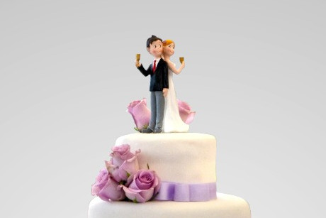 A wedding couple on top of the cake