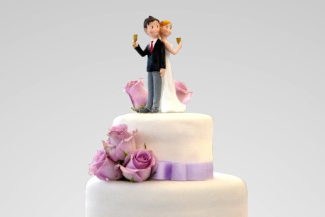 A wedding couple on top of the cake