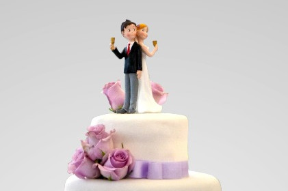A wedding couple on top of the cake