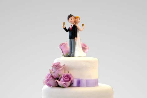 A wedding couple on top of the cake