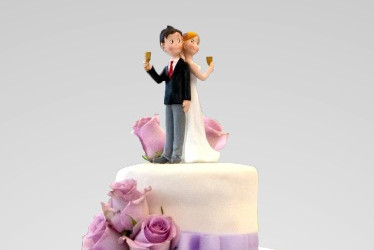 A wedding couple on top of the cake