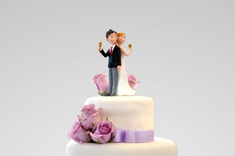 A wedding couple on top of the cake