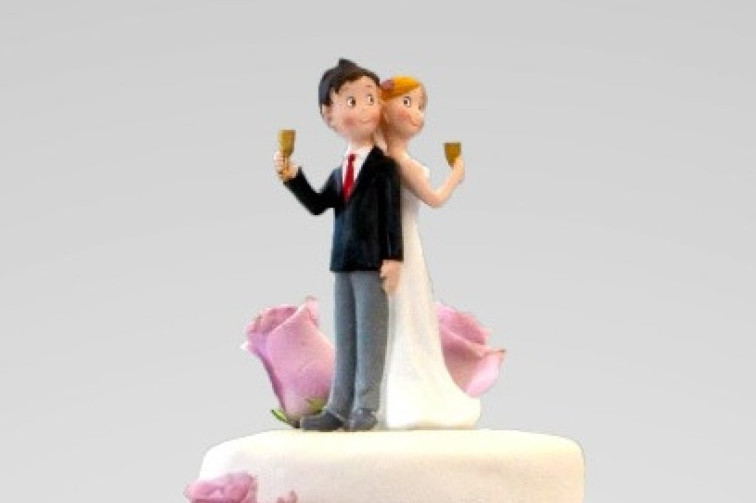 A wedding couple on top of the cake