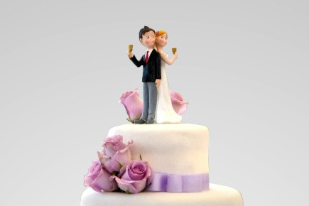 A wedding couple on top of the cake